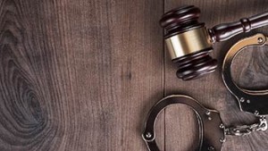 hand cuffs and wooden legal hammer