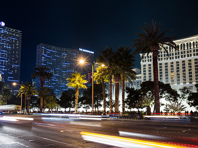 las vegas strip at night in front of casinos blurred lights