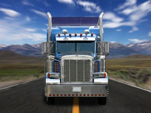 semi truck front on blurred highway